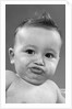 1950s baby making a funny face and bronx cheer noise looking at camera by Anonymous