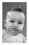 1950s baby making a funny face and bronx cheer noise looking at camera by Anonymous