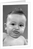 1950s baby making a funny face and bronx cheer noise looking at camera by Anonymous