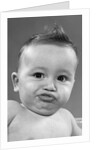 1950s baby making a funny face and bronx cheer noise looking at camera by Anonymous