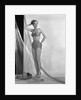 1950s glamour girl looking at camera posed in studio draped in fishing net wearing two piece bathing suit by Anonymous