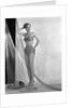 1950s glamour girl looking at camera posed in studio draped in fishing net wearing two piece bathing suit by Anonymous