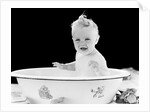 1930s 1940s smiling happy baby sitting in enameled tin bathtub by Anonymous