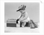 1940s baby in railroad engineer hat pulling milk bottle from lunch pail with hammer & wrench tools at side studio by Anonymous