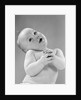1950s baby in diaper head to one side arms hands clasped in front by Anonymous