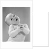 1950s baby in diaper head to one side arms hands clasped in front by Anonymous