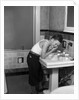 1930s boy washing face at bathroom sink by Anonymous