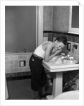 1930s boy washing face at bathroom sink by Anonymous