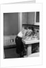 1930s boy washing face at bathroom sink by Anonymous