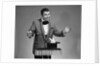 1960s man magician wearing tuxedo white rabbit peaking our of top hat by Anonymous