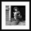 Girl posing with calf in straw filled stall in barn by Anonymous