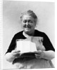 1930s 1940s elderly character woman smiling reading letter wearing apron looking at camera by Anonymous