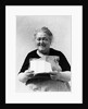 1930s 1940s elderly character woman smiling reading letter wearing apron looking at camera by Anonymous