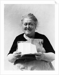 1930s 1940s elderly character woman smiling reading letter wearing apron looking at camera by Anonymous