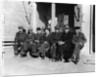 1920s 1930s group of old men in hats & dungarees sitting on bench in front of store window looking at camera by Anonymous