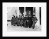 1920s 1930s group of old men in hats & dungarees sitting on bench in front of store window looking at camera by Anonymous