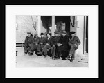 1920s 1930s group of old men in hats & dungarees sitting on bench in front of store window looking at camera by Anonymous