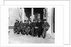 1920s 1930s group of old men in hats & dungarees sitting on bench in front of store window looking at camera by Anonymous