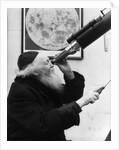 1930s old astronomer white hair and beard wearing skull cap looking through telescope by Anonymous