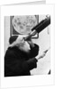 1930s old astronomer white hair and beard wearing skull cap looking through telescope by Anonymous