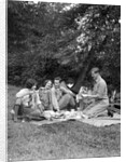 1920s four people two couples men women sitting on ground enjoying a picnic by Anonymous