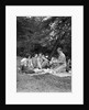 1920s four people two couples men women sitting on ground enjoying a picnic by Anonymous