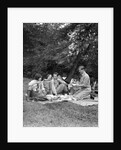 1920s four people two couples men women sitting on ground enjoying a picnic by Anonymous