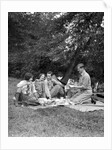 1920s four people two couples men women sitting on ground enjoying a picnic by Anonymous