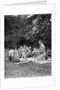 1920s four people two couples men women sitting on ground enjoying a picnic by Anonymous