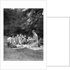 1920s four people two couples men women sitting on ground enjoying a picnic by Anonymous