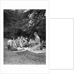 1920s four people two couples men women sitting on ground enjoying a picnic by Anonymous