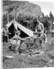 1920s 1930s two men and one woman eating a meal around a campfire with a tent and horses at baker lake alberta canada by Anonymous