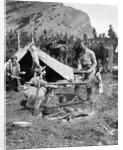 1920s 1930s two men and one woman eating a meal around a campfire with a tent and horses at baker lake alberta canada by Anonymous