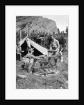 1920s 1930s two men and one woman eating a meal around a campfire with a tent and horses at baker lake alberta canada by Anonymous