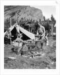 1920s 1930s two men and one woman eating a meal around a campfire with a tent and horses at baker lake alberta canada by Anonymous
