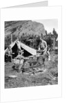 1920s 1930s two men and one woman eating a meal around a campfire with a tent and horses at baker lake alberta canada by Anonymous