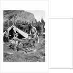 1920s 1930s two men and one woman eating a meal around a campfire with a tent and horses at baker lake alberta canada by Anonymous