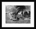 1920s 1930s two women at campsite woman cooking preparing food over campfire horses with riding gear in background by Anonymous