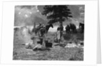 1920s 1930s two women at campsite woman cooking preparing food over campfire horses with riding gear in background by Anonymous