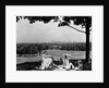 1930s 1940s family picnicking under a tree in fairmont park with skyline of philadelphia pa on horizon by Anonymous