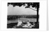 1930s 1940s family picnicking under a tree in fairmont park with skyline of philadelphia pa on horizon by Anonymous