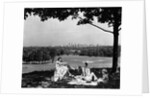 1930s 1940s family picnicking under a tree in fairmont park with skyline of philadelphia pa on horizon by Anonymous