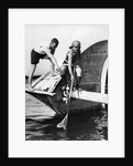 1920s man and woman in bathing suits crabbing off old abandoned wooden boat by Anonymous