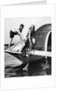 1920s man and woman in bathing suits crabbing off old abandoned wooden boat by Anonymous