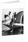 1920s man and woman in bathing suits crabbing off old abandoned wooden boat by Anonymous