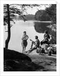 1920s 1930s 3 people picnicking by onata lake man wearing jodhpurs standing two seated women berkshires ma usa by Anonymous