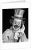 1950s portrait of clown wearing top hat smiling looking at camera by Anonymous