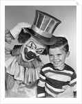 1950s smiling clown with top hat arm around grinning boy in striped shirt by Anonymous