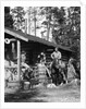 1920s 1930s couple in front of log cabin woman sitting on porch railing man on horse alberta canada by Anonymous