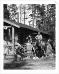 1920s 1930s couple in front of log cabin woman sitting on porch railing man on horse alberta canada by Anonymous